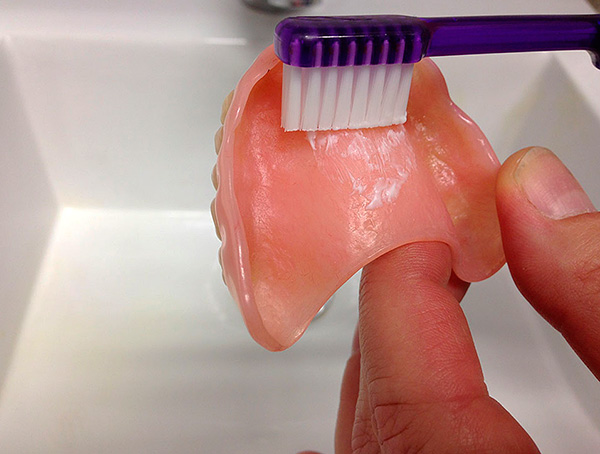 Cuide da prótese acrílica usando uma escova de dentes e creme dental regulares.