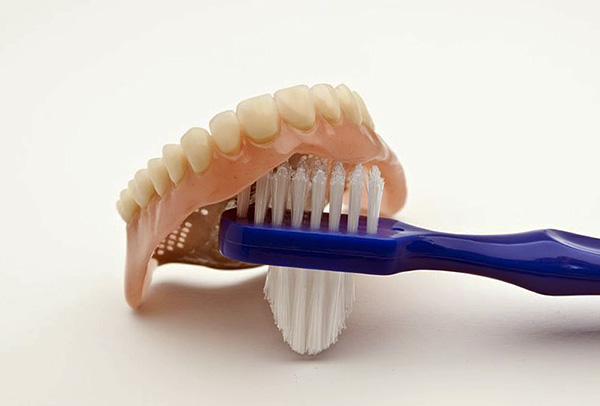 Você pode usar escovas de dentes especiais para limpar próteses removíveis.